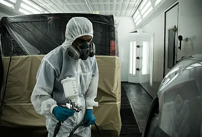 A vehicle masked up inside the spray booth